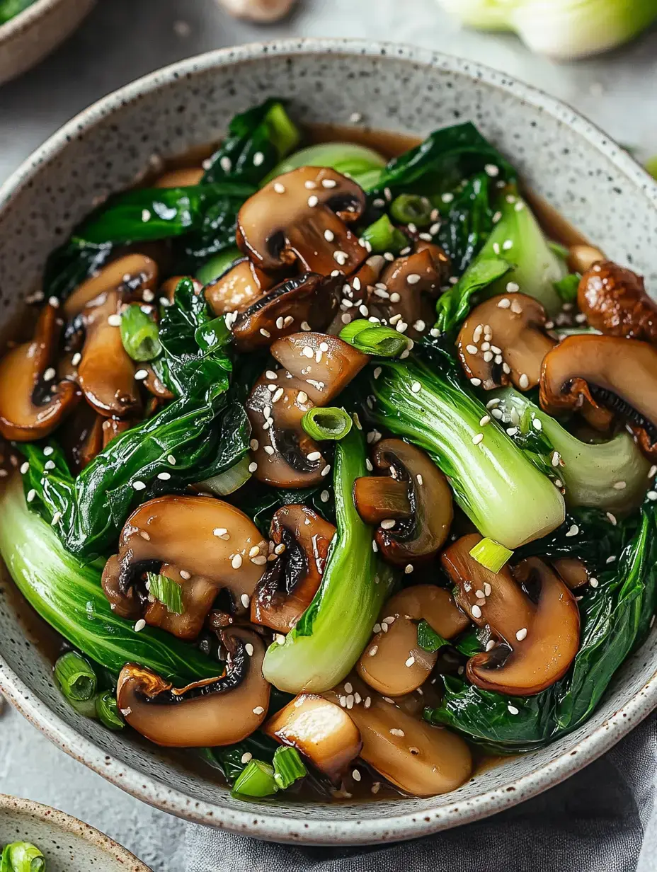 A bowl of sautéed mushrooms and bok choy garnished with sesame seeds and green onions.