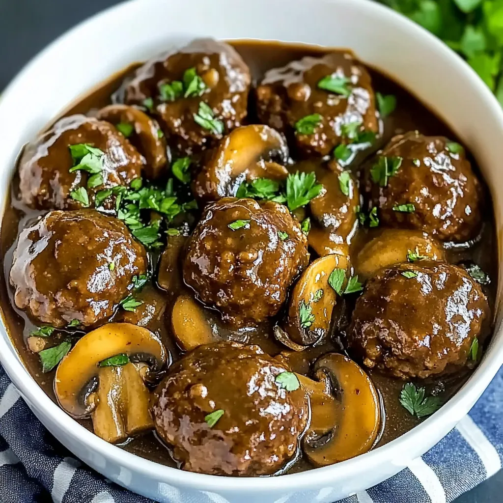 A bowl of meatballs in a brown sauce.