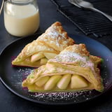 Two apple pastries on a plate.