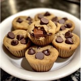 A plate of chocolate chip cookies with a bite taken out of one.