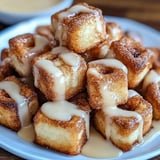 A plate of sugar covered doughnuts.