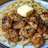 A plate of chicken and noodles.