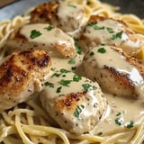 Chicken and pasta with sauce.