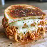 A sandwich with spaghetti and cheese.
