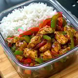 A container of rice and chicken.