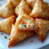 A plate of food with a triangle shaped food item.